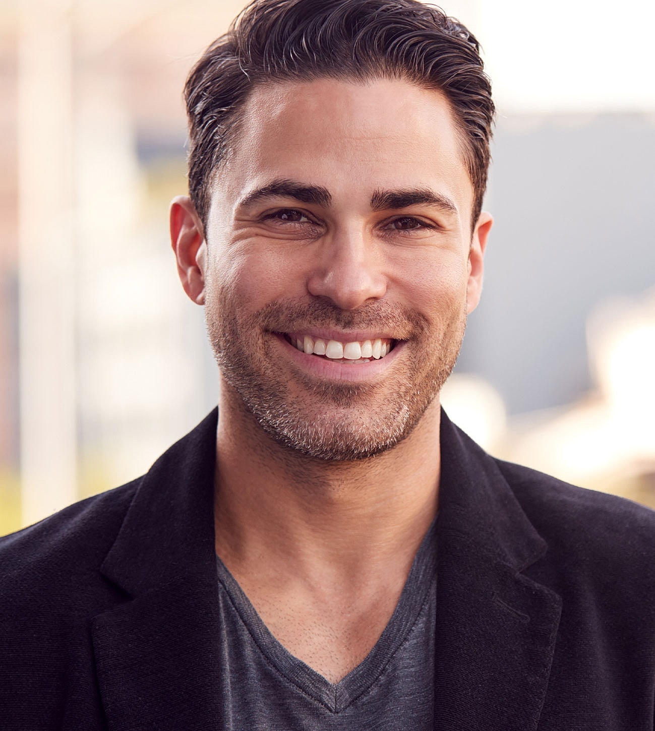 Smiling man in casual outdoor setting.