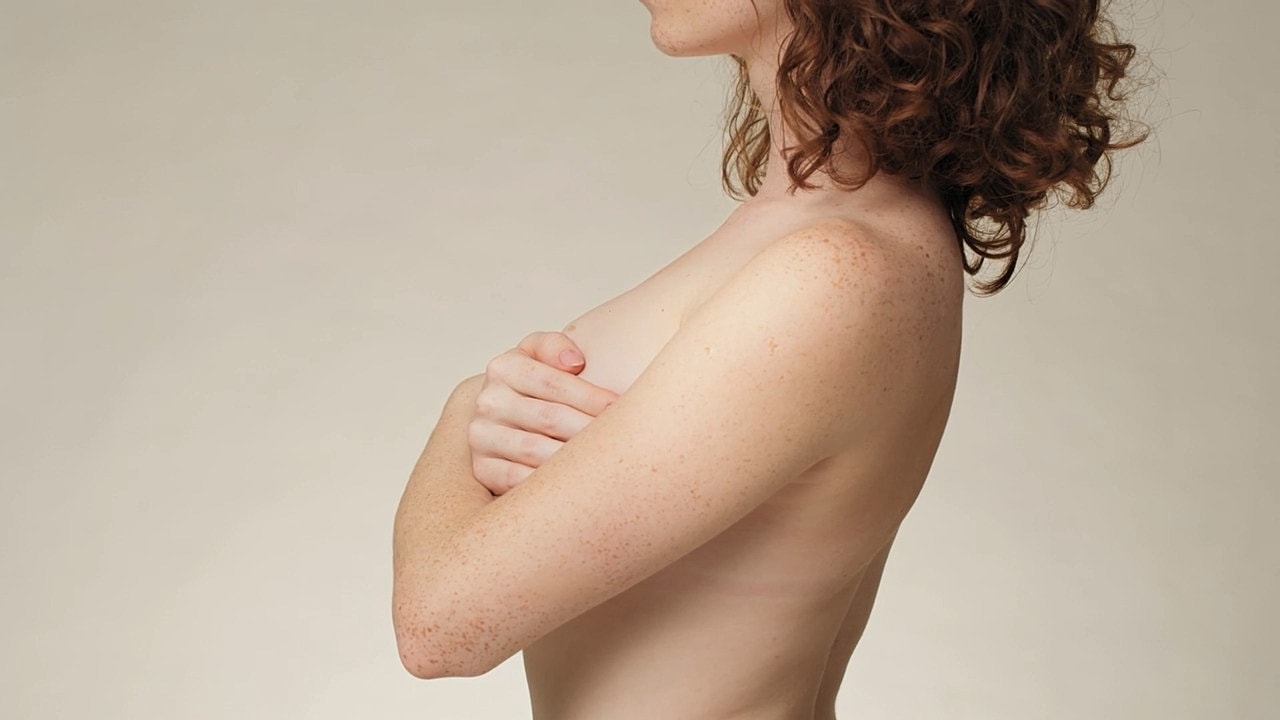 Side profile of a woman with curly hair.