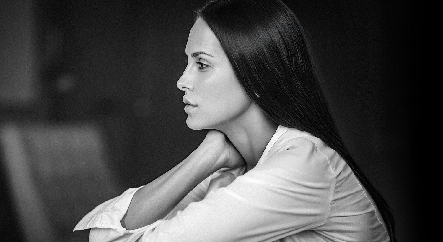 Profile of a woman lost in thought.